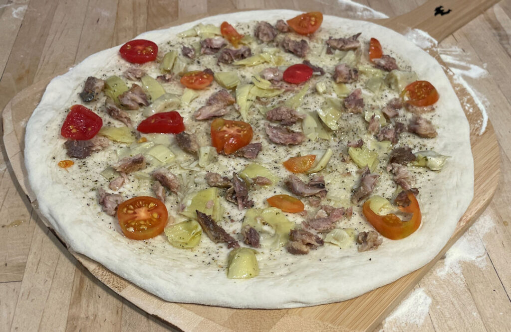 Topping the sardine pizza
