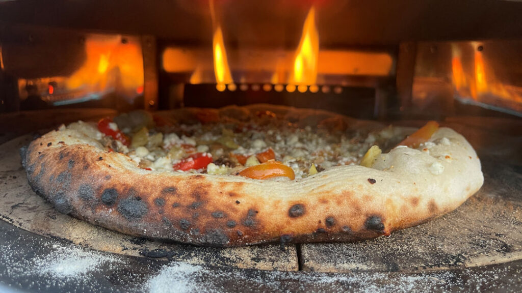 Sardine pizza in the oven - rotate it!