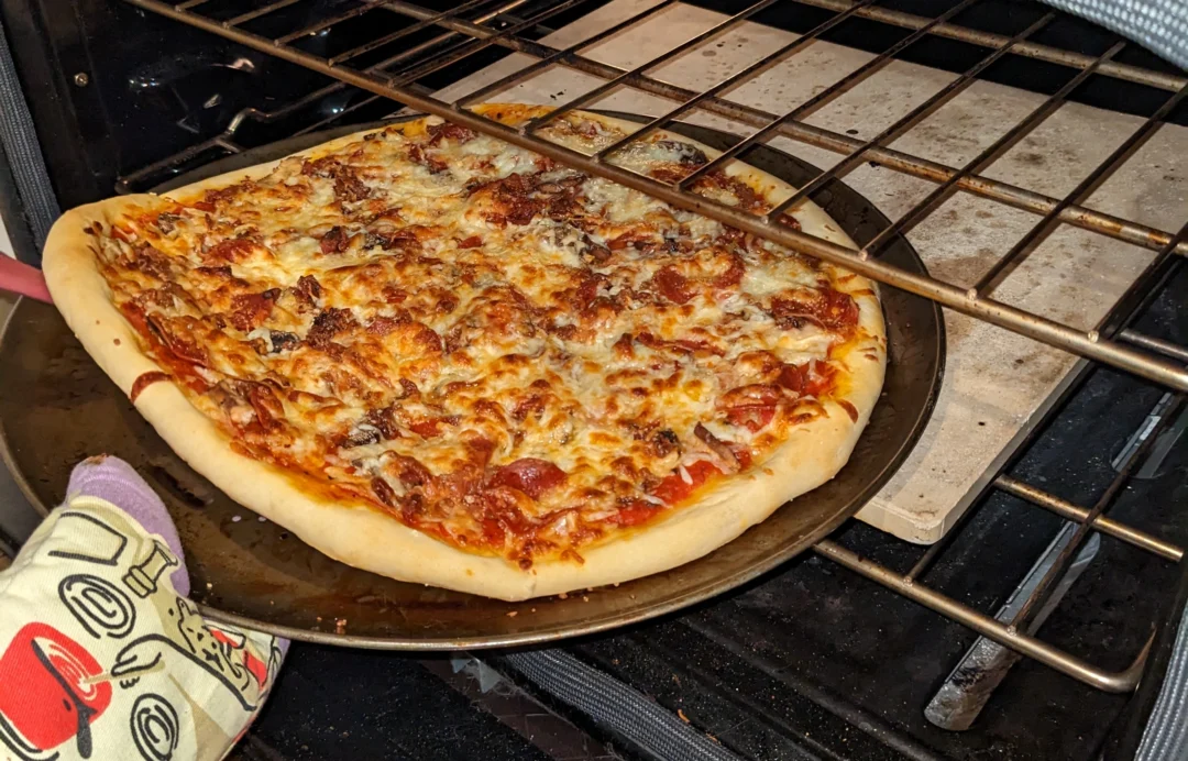 Launch that almost cooked pizza from the pan to the stone to finish the bottom!