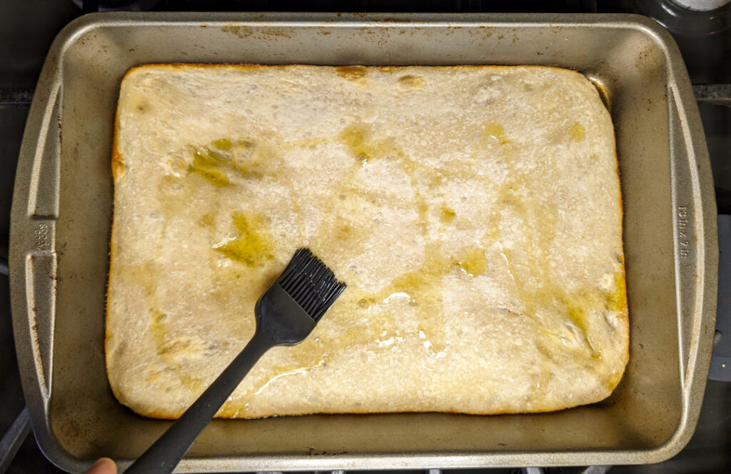 Oil the parbaked dough.