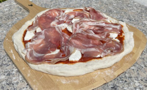 Topping a Spiral Bacon Pizza