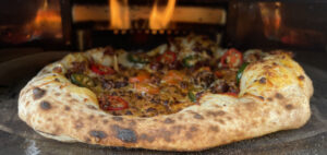 Pizza con chorizo in the pizza oven