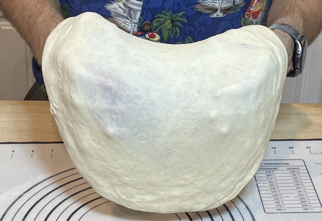 Stretching the dough on your fists.