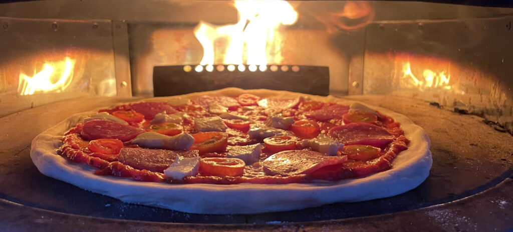 Pizza cooking in the pizza oven.