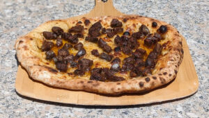 Remove the pizza from the oven when the crust is browning.