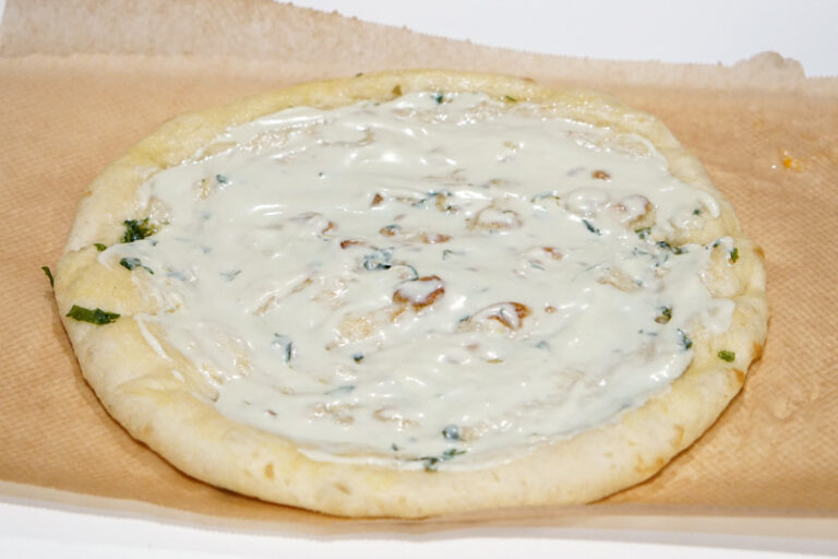 Add the blue cheese dressing to the Buffalo Chicken Pizza