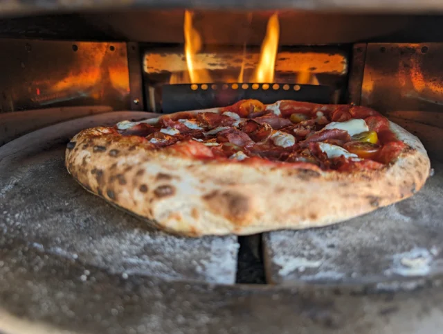 Cooking our tomato and speck pizza.