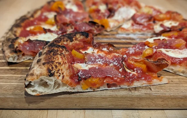 Speck & Tomato Pizza in cross section.